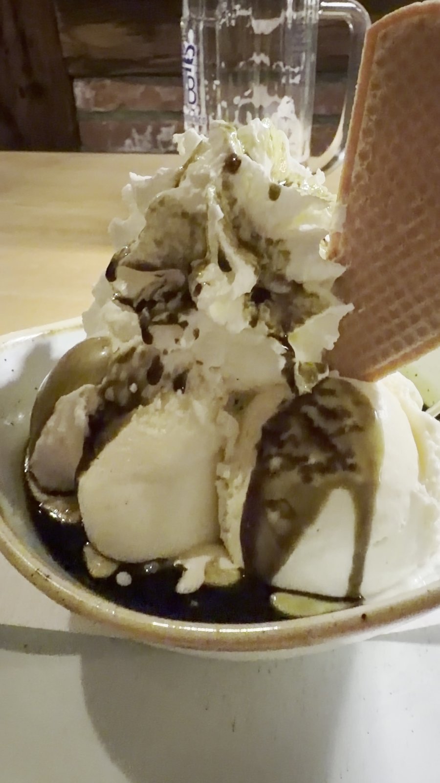 Vanilla ice cream with pumpkin seed oil syrup and whipped cream at Voitlhof Tegernsee