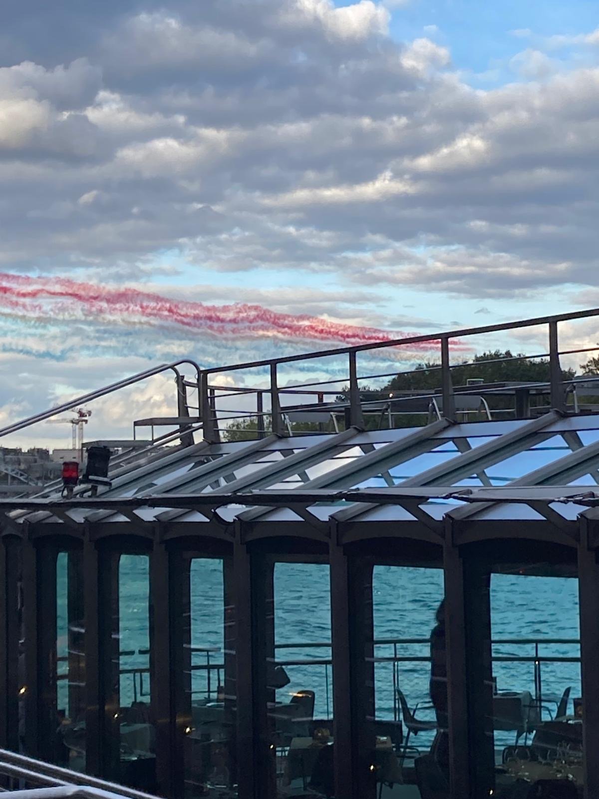 Patrouille de France with tricolour smoke trails over the Seine