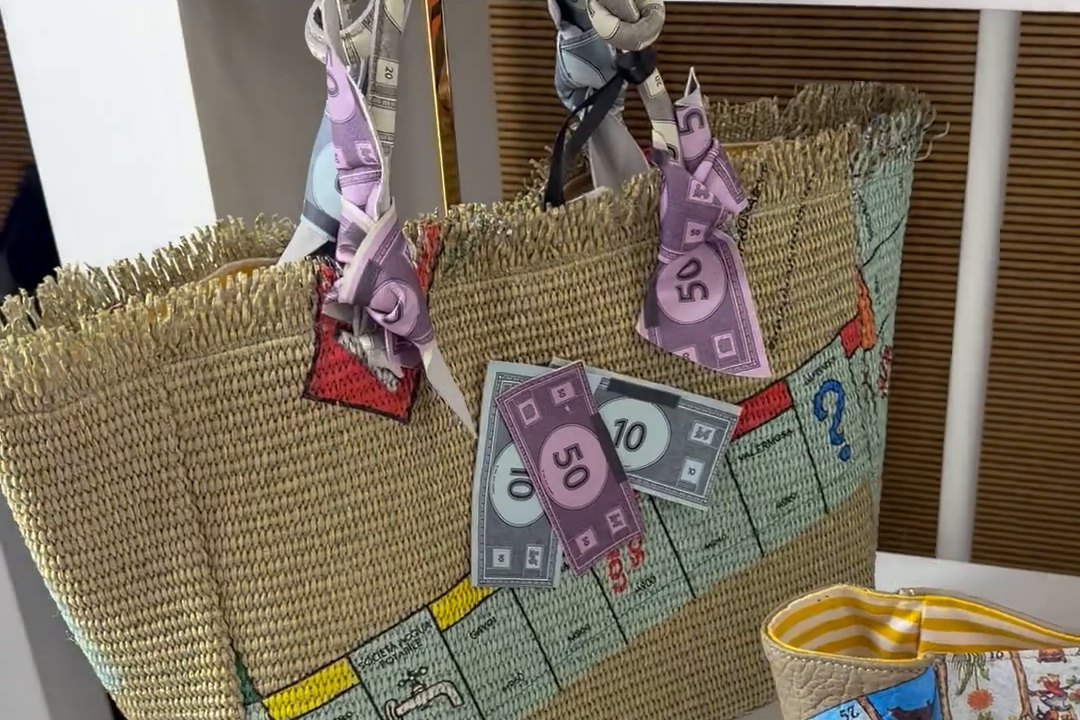 Bag by Anita Bilardi with a Monopoly design, individually printed banknotes hanging from the handles