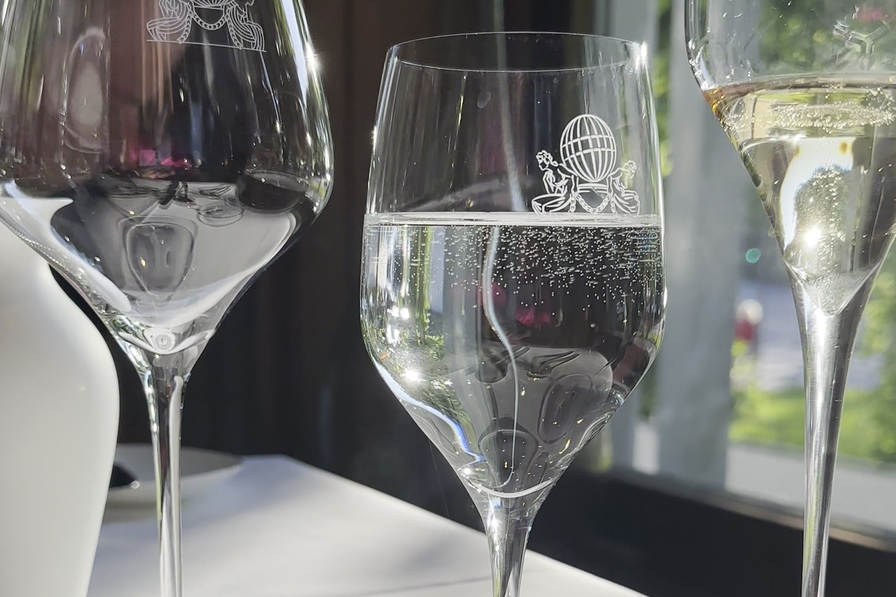 A laid window table in the restaurant of Hotel Atlantic with glasses and a white cloth.