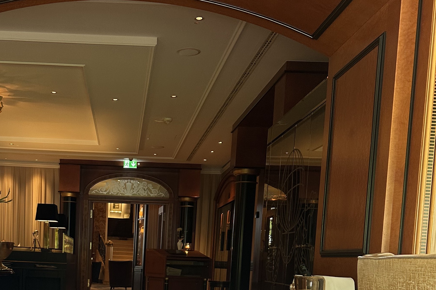 A view through the restaurant salon with laid tables and tall windows.