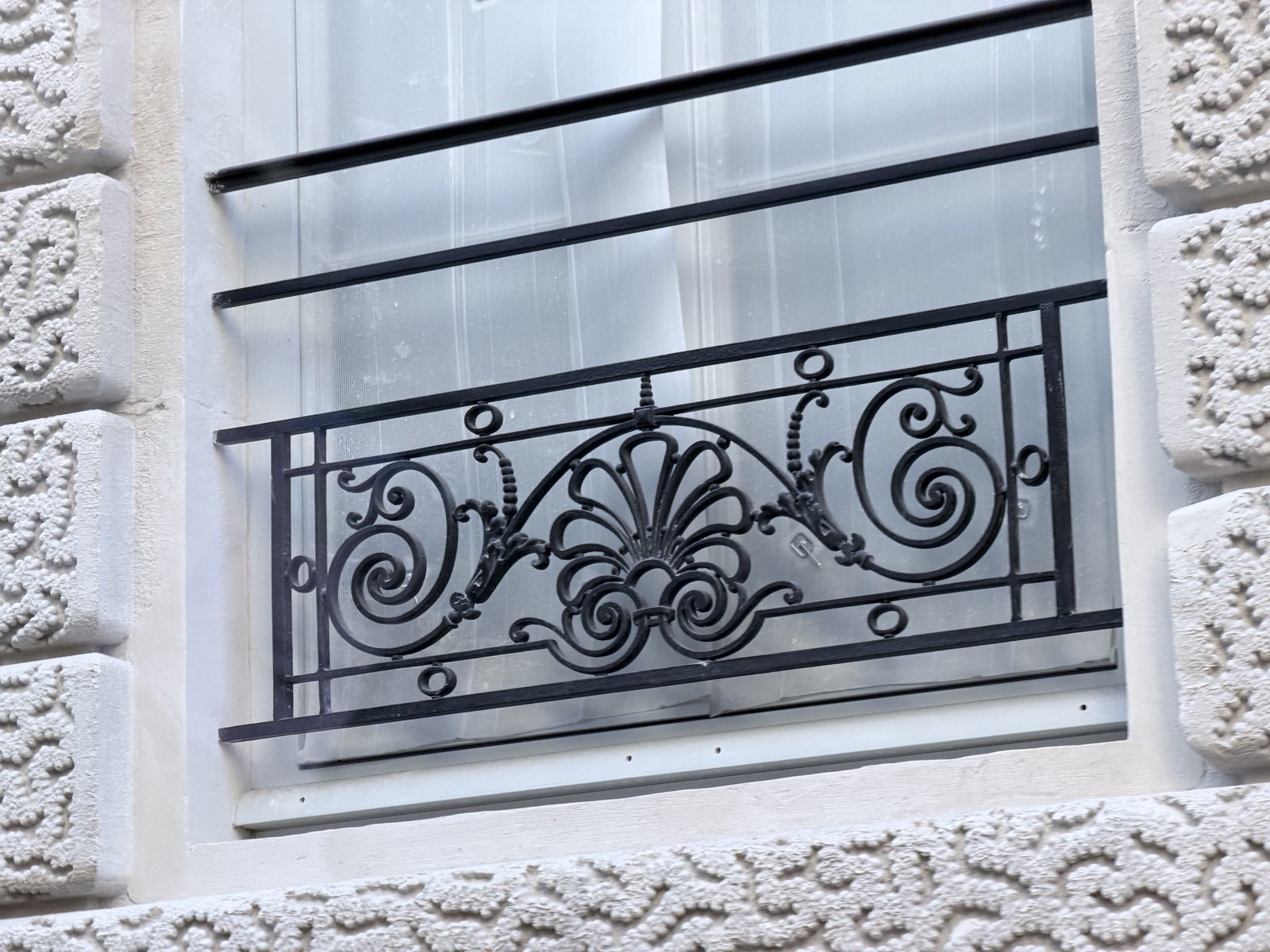 Wrought iron balcony railing on a Paris house front